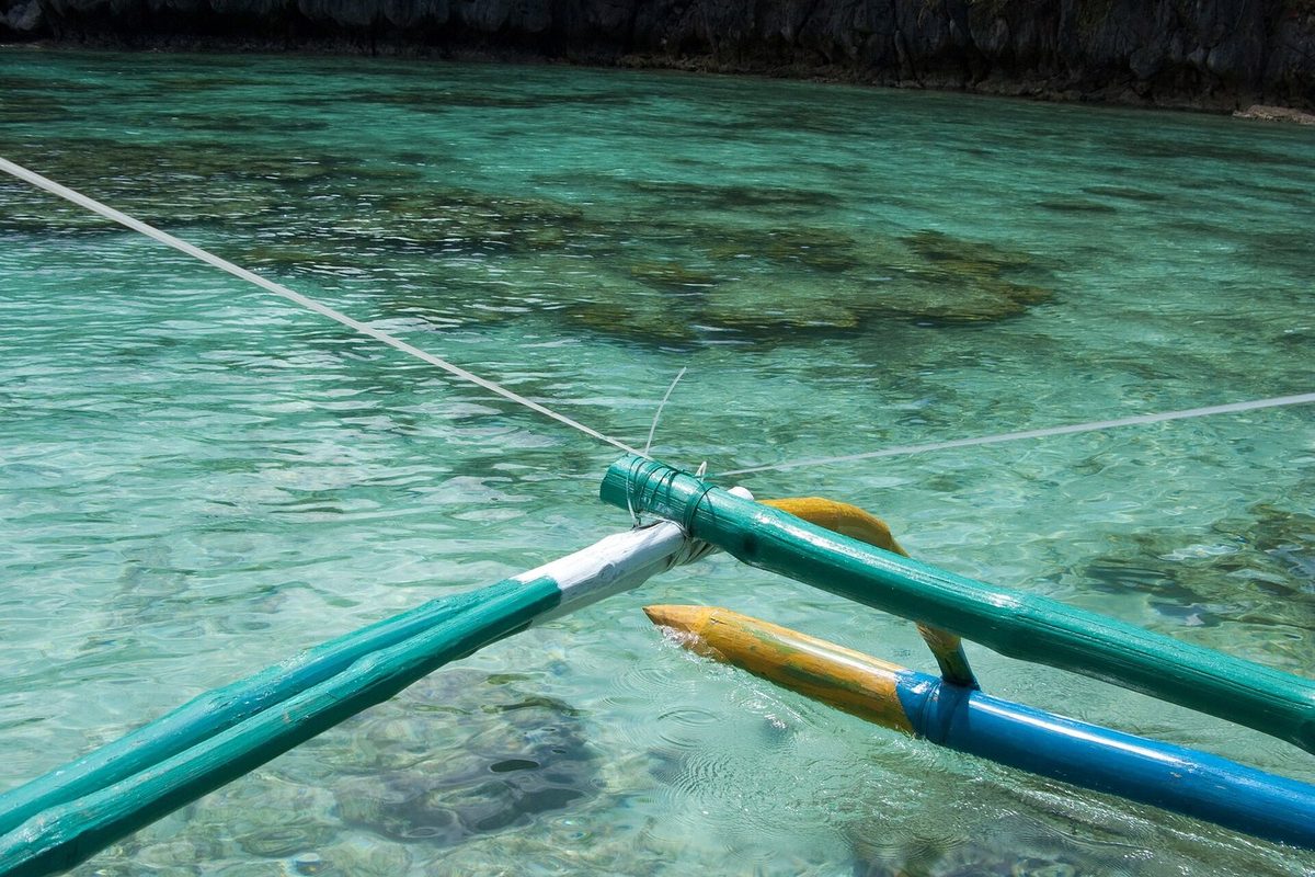 Outrigger boat in clear water near El Nido, Philippines