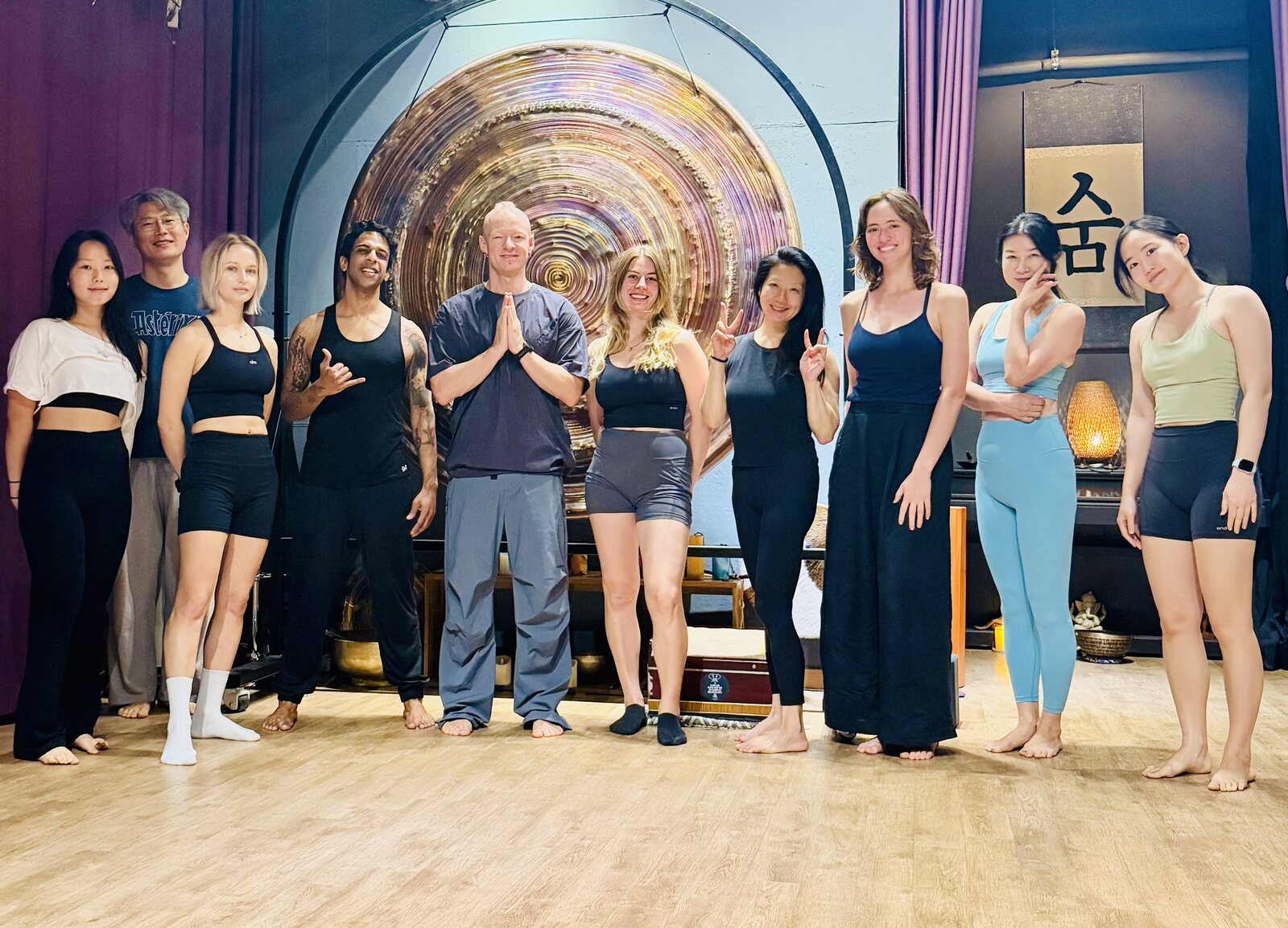 A Move Breathe Play class standing together after a movement session in an indoor studio